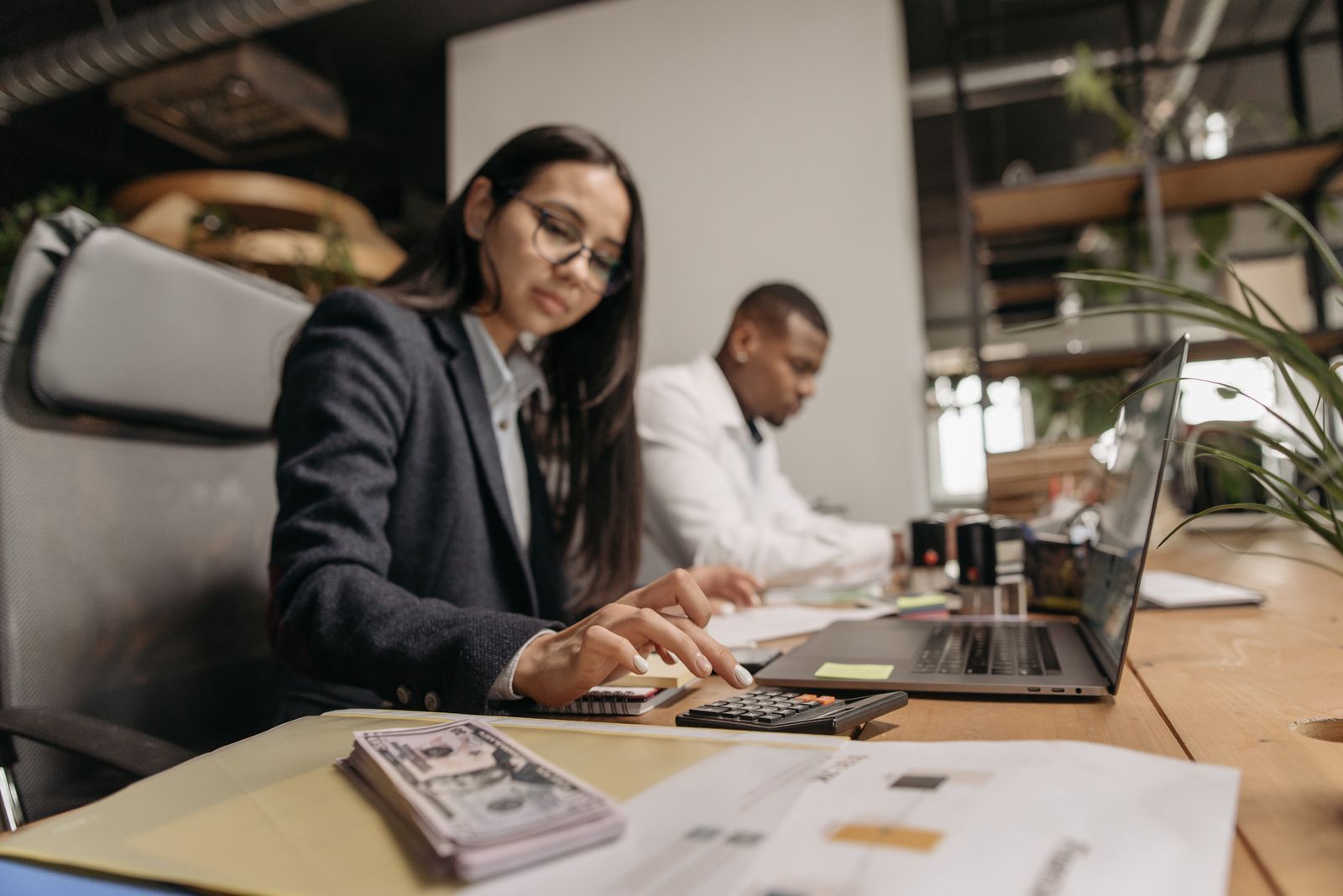 An accountant and a colleague reviewing figures at a laptop