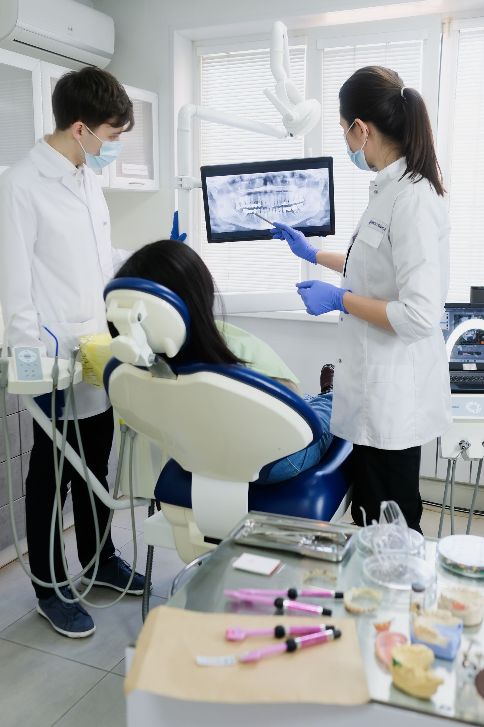 A dentist with a patient in the chair