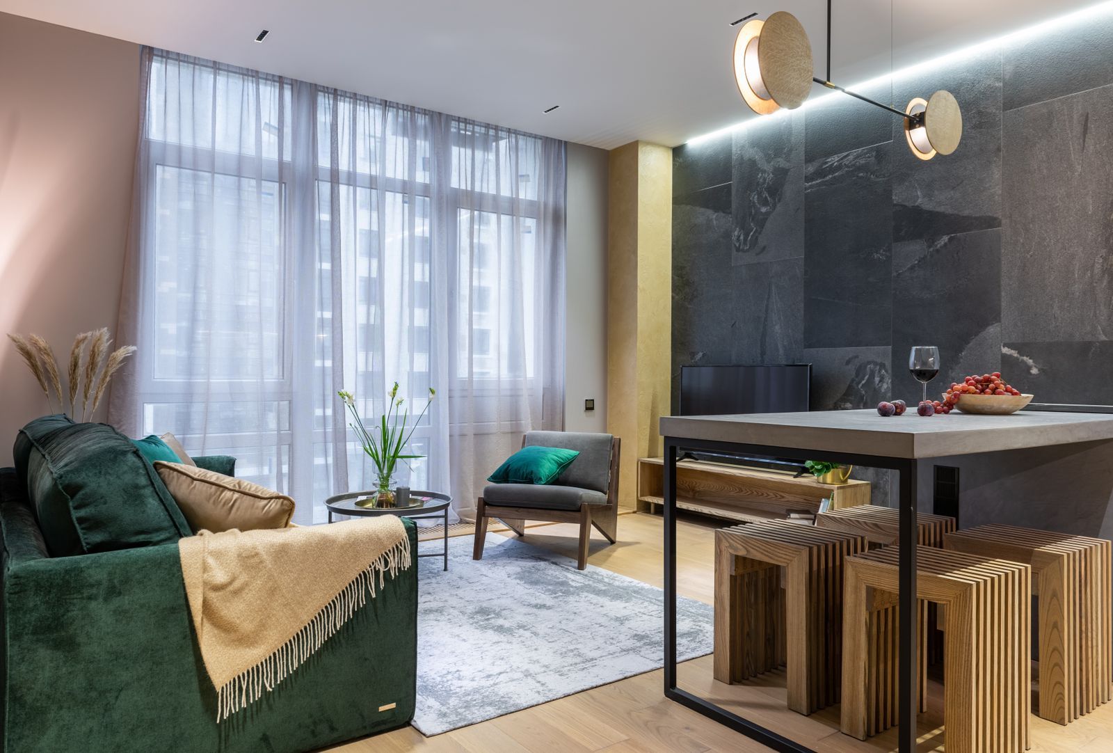 A modern living room with a sofa, armchair and dining table