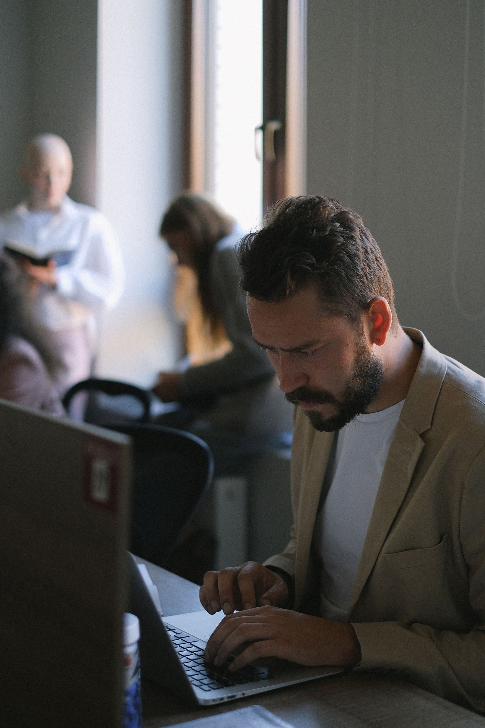 A team member working on a laptop in an office