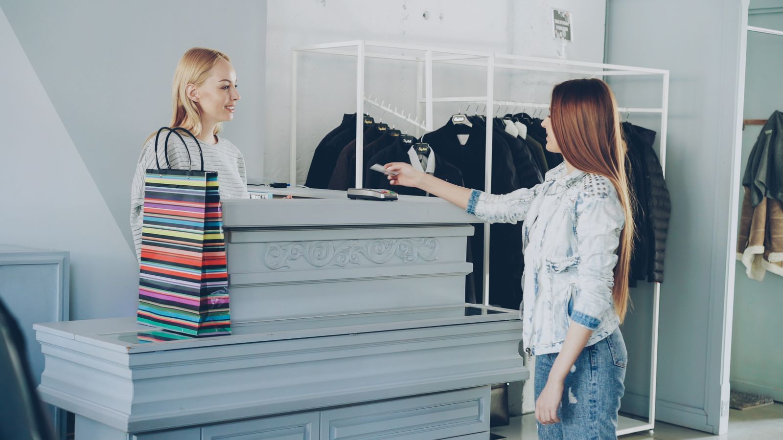 A customer paying by card at a retail counter