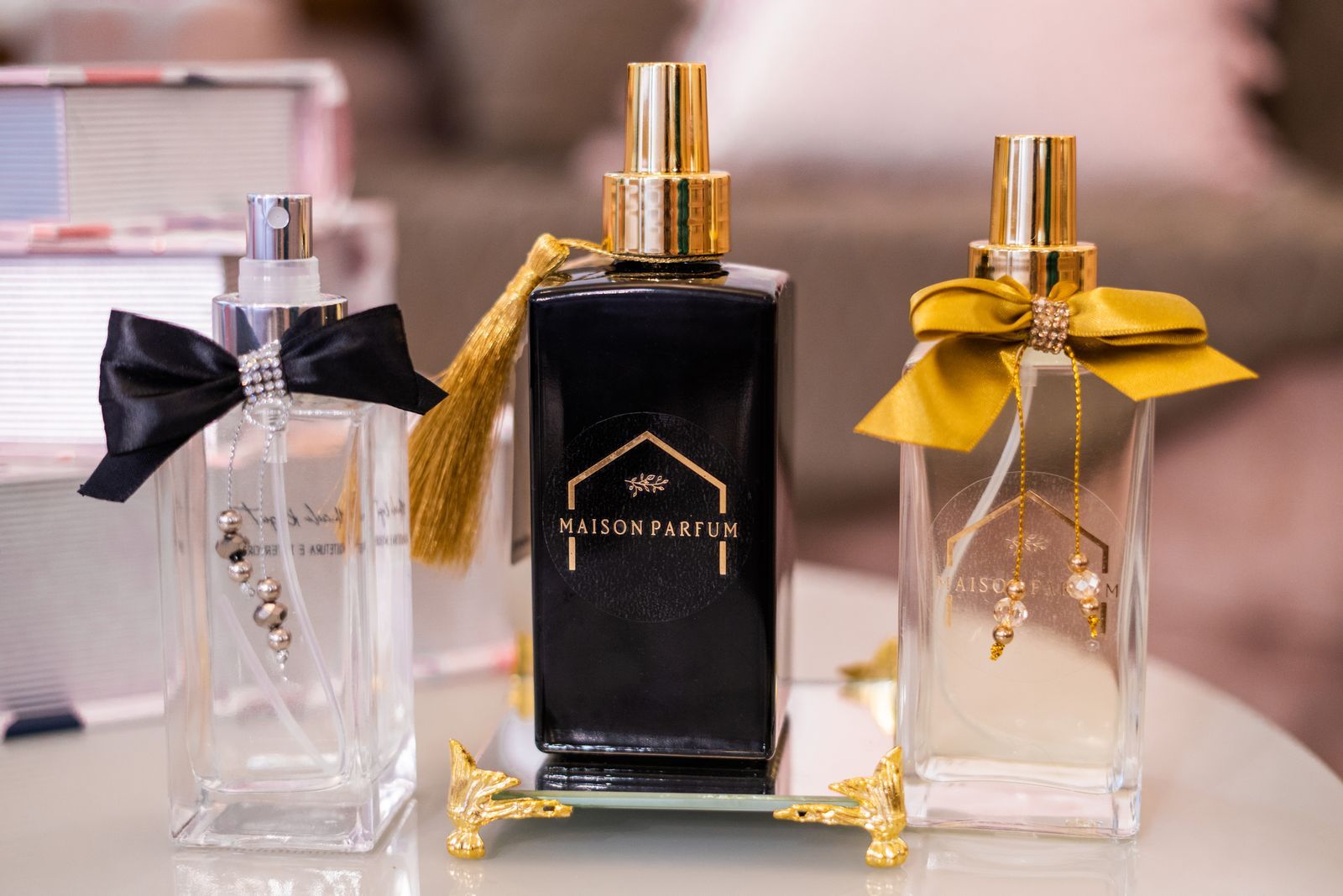 Luxury perfume bottles with gold ribbons on a counter