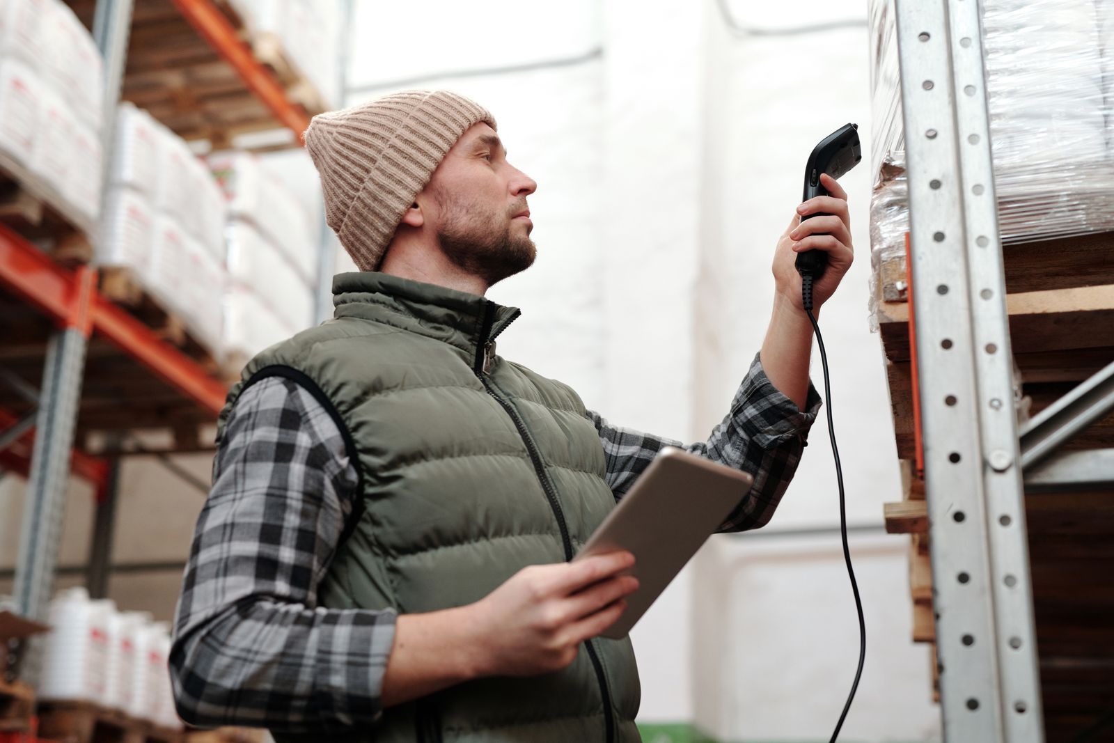 A warehouse worker scanning stock on the shelves